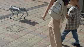 Woman and her young son walking down a city street with a futuristic four-legged robot companion - Powered by Shutterstock - Get 15% off with code: PIKWIZARD15