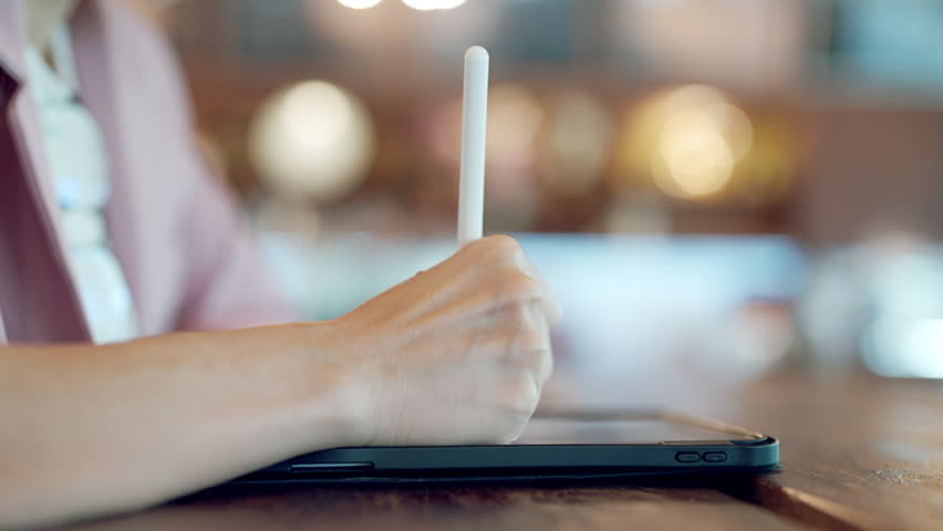 Close-up of UX UI designer hand using stylus pen on digital tablet, modern user interface design concept