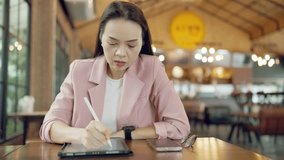 Close-up of businesswoman checking time and planning tasks on tablet using stylus and smartwatch in office environment - Powered by Shutterstock - Get 15% off with code: PIKWIZARD15