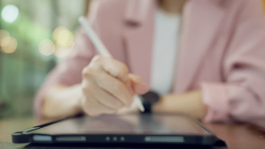 Creative female hand using stylus pen for graphic design on tablet screen, concept of digital illustration and creativity