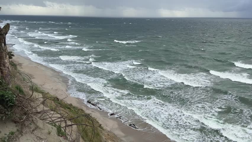 High point view storm sea sandy beach wreck remains old ship wood sticking from sand waves crashing coast dramatic horizon ocean seascape wild weather landscape