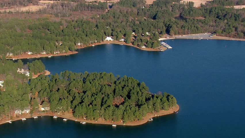 Aerial view of a beautiful lake surrounded by lush green forests