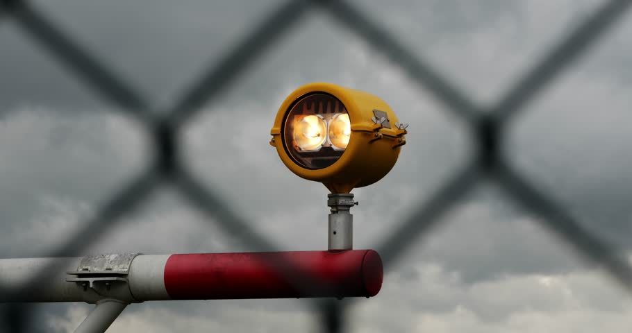 Airport runway precision approach path indicators lights in yellow metal casing. Close up, telephoto shot, shallow depth of field, no people
