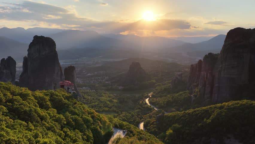 golden sunset over rocks of Meteora with Greek orthodox monasteries, unesco world heritage site, Greece travel landscape 