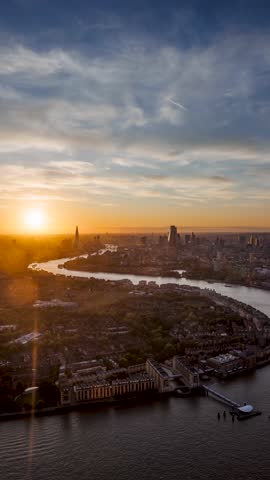 Panoramic sunset to night time lapse view of the skyline of London, England, with River Thames leading into the City