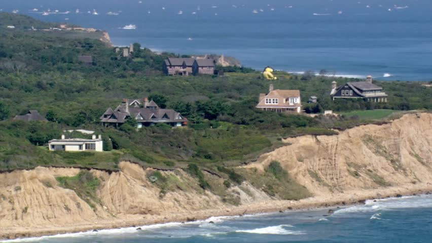 Coastal homes perch atop a cliff overlooking the ocean in montauk, new york