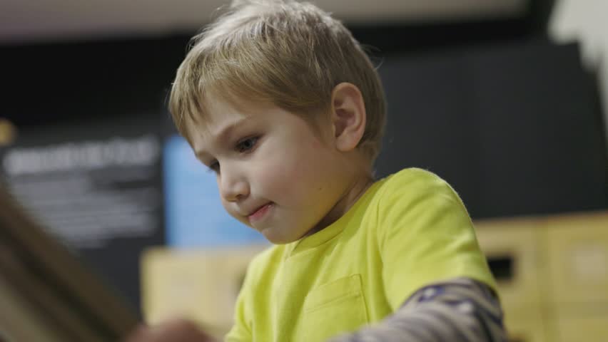 Concentrated little boy playing an interactive game