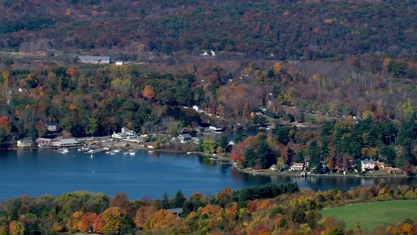 A scenic view of a lake surrounded by colorful trees in the autumn season