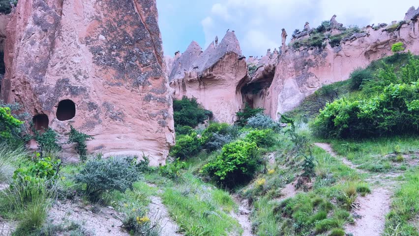 The picturesque Zelve Valley in cloudy weather in Turkey. Unusual rock formations that tell ancient stories about Cappadocia. Rocks that once had houses carved by ancient inhabitants. 4K