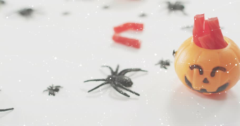 After one second overlays fading, sliding over pumpkin and spider as snow drifting for data updates. Festive, seasonal, digital, technology, mockup, halloween, modern