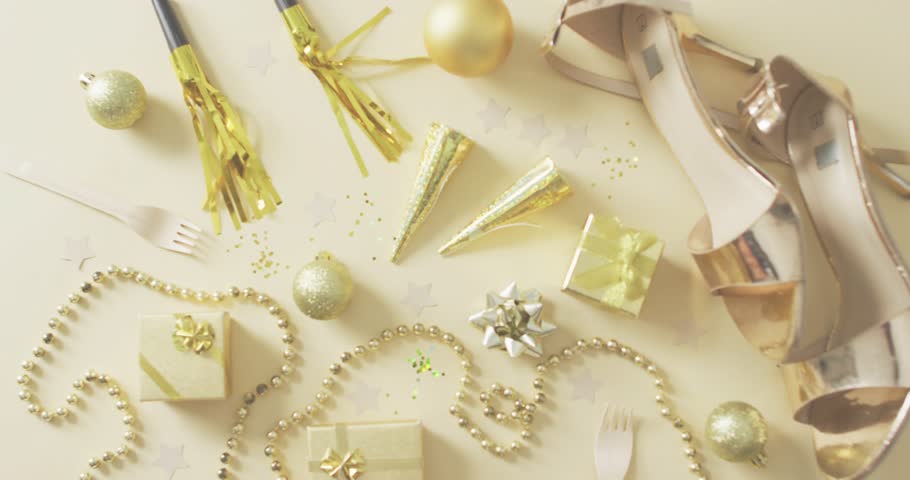 Confetti fragments starting at left edge drifting and settling over gold decor for festive overlay. Celebration, glamour, elegance, festive, shimmer, luxury, joyous