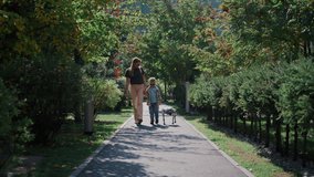 Rear view of a family with a futuristic pet robot walking on a path surrounded by green trees - Powered by Shutterstock - Get 15% off with code: PIKWIZARD15