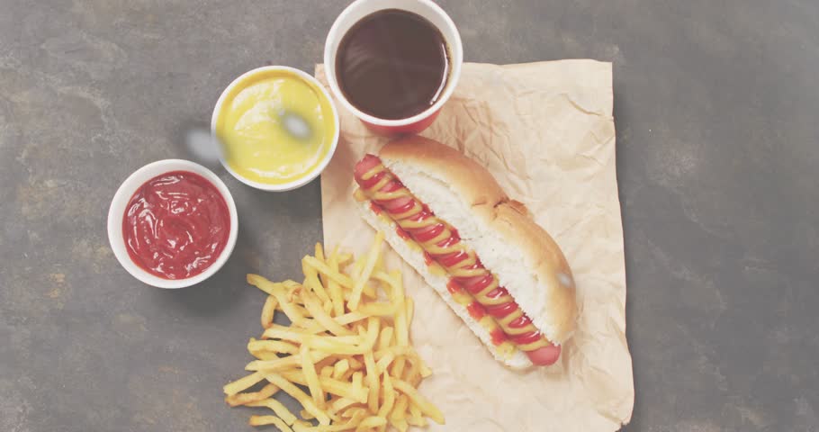 Hot dog and fries staying static while code overlay appearing and charts sliding showing meal data. Fast food, digital analytics, technology, data visualization, minimalist, contemporary, consumer