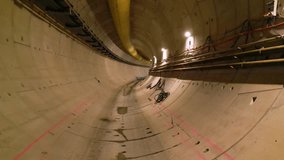 Underground metro tunnel interior during construction with concrete segment lining, utility cables, ventilation ducts, and dim industrial lighting in progress of large infrastructure engineering proje - Powered by Shutterstock - Get 15% off with code: PIKWIZARD15