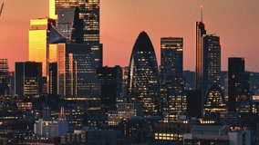 England, London: Aerial view of the illuminated London skyline during a vibrant sunset, showcasing famous landmarks and modern buildings, capturing the dynamic energy of the city's financial district - Powered by Shutterstock - Get 15% off with code: PIKWIZARD15
