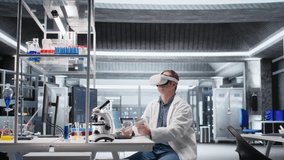 Scientist in futuristic laboratory uses VR glasses to simulate molecular experiments. Virtual reality tech supports biotechnology research and advanced medical discovery in healthcare. Camera A. - Powered by Shutterstock - Get 15% off with code: PIKWIZARD15