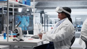 African american expert using VR glasses in lab for molecular research, virtual reality gadgets helping with biotechnology and genetics research. Modern interactive tech in laboratory. Camera B. - Powered by Shutterstock - Get 15% off with code: PIKWIZARD15