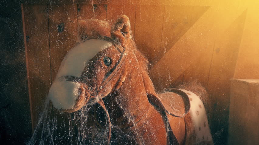 Sun Lights Up Old Rocking Horse In Dusty Attic
