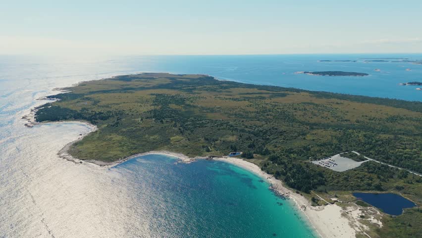 Aerial View Shows Pristine Shoreline Of Nova Scotia, Canada, Where Atlantic Waves Touch White Sand And Remote Islands Enhance The Natural Beauty Of The Scene. 