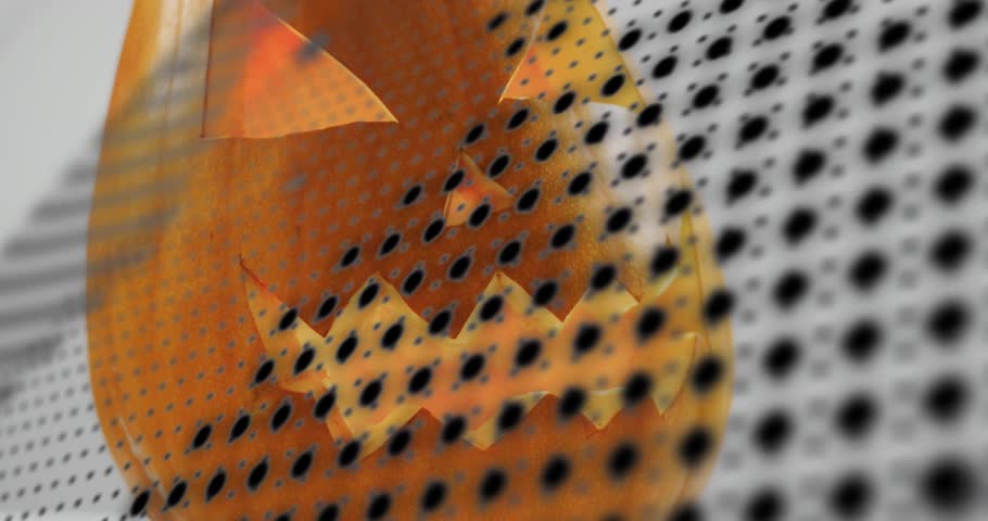 Halftone dots appearing at right edge sweeping carved pumpkin face then receding revealing glow. Autumn, harvest, decoration, graphic, digital, abstract, seasonal