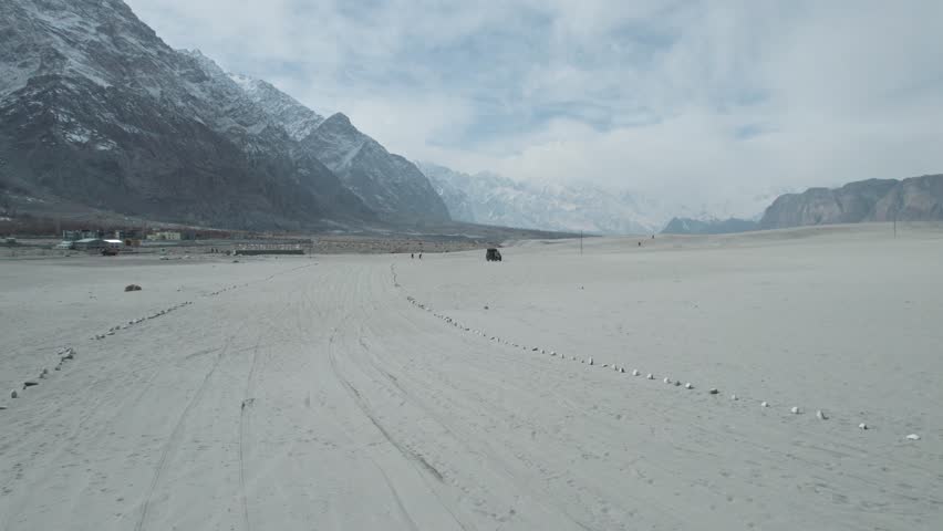 Beautiful drone view of desert in Gilgit Baltistan, Pakistan. Beautiful snow capped mountains, beautiful valleys, cloudy weather, spa nature, northern area of Pakistan, travelling, beauty. 