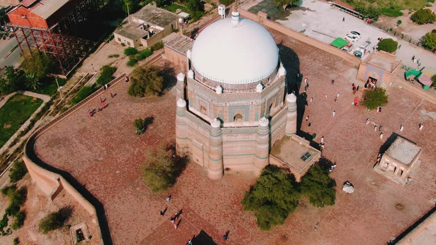 Aerial view of historic mausoleum with white dome in Multan
