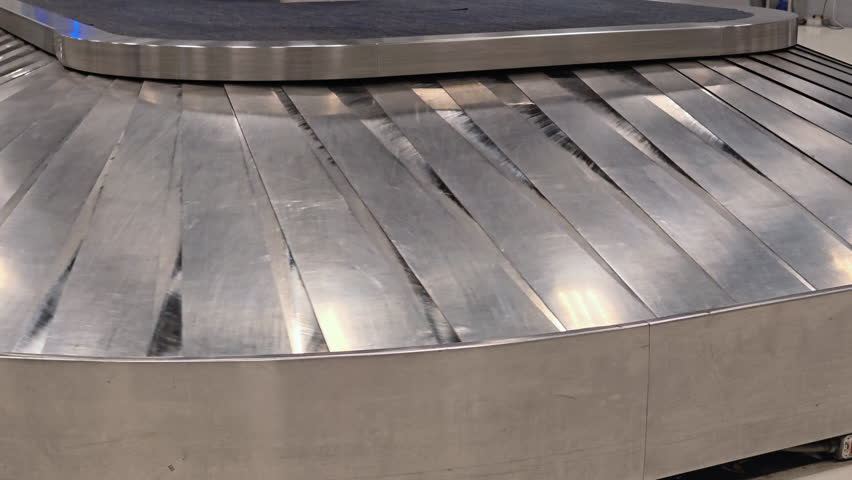 Luggage airport baggage conveyor belt travel transportation metal terminal arrival carousel claim shiny industrial horizontal waiting area modern