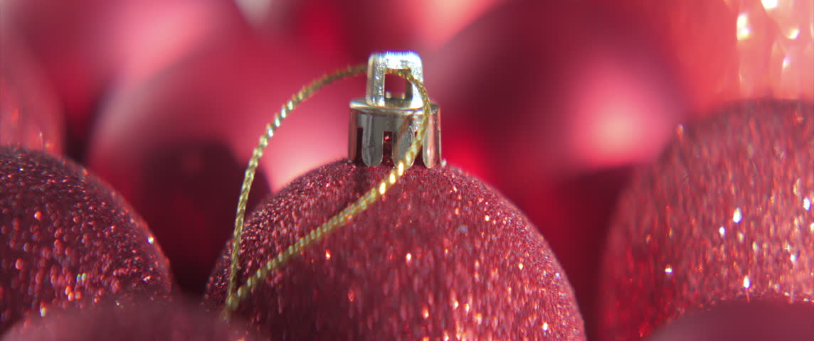 Detailed red Christmas balls with strings 4K scope sliding video