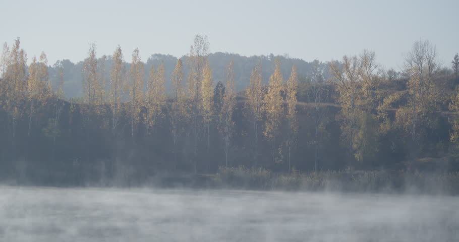 Beautiful autumnal scenery with fog on lake waters 4K footage