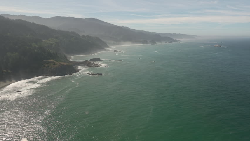 Flying over the Pacific Ocean at the Southern Oregon Coast with mist and atmospheric conditions.