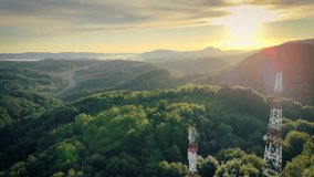 Wide landscape panorama of telecom towers sending bright neon communication streams across rolling green hills, capturing futuristic wireless data transfer and seamless rural network coverage - Powered by Shutterstock - Get 15% off with code: PIKWIZARD15