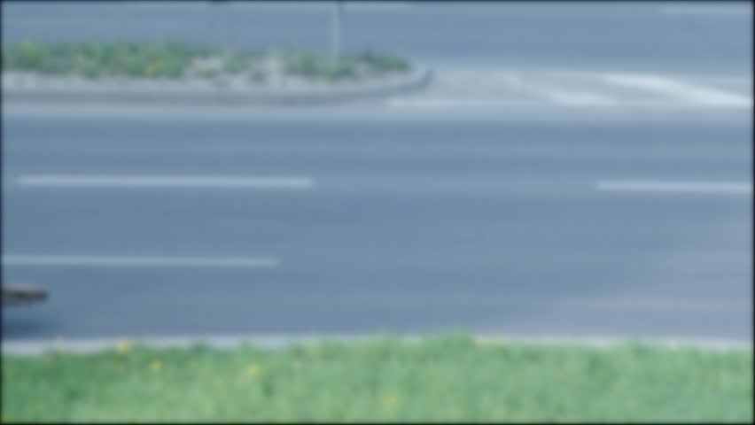 Blue tractor with brush removes sand on the road, background, industry. Copy space for text, urban, blurry