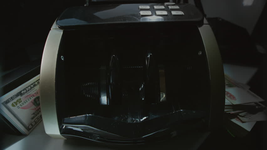 Money counting machine bank machine close up. 100 American dollar bills. Business finance, cash. Seller, broker considers the client's finances. Economic crisis in USA. Paper banknote. Wide angle lens