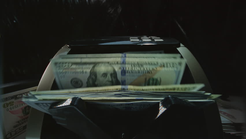Money counting machine bank machine close up. 100 American dollar bills. Business finance, cash. Seller, broker considers the client's finances. Economic crisis in USA. Paper banknote. Wide angle lens