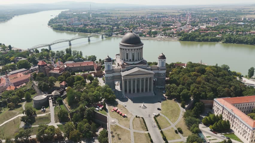 Sweeping aerial orbit of Hungary’s Esztergom Basilica, capturing its grand architecture and panoramic views of the Danube River.
