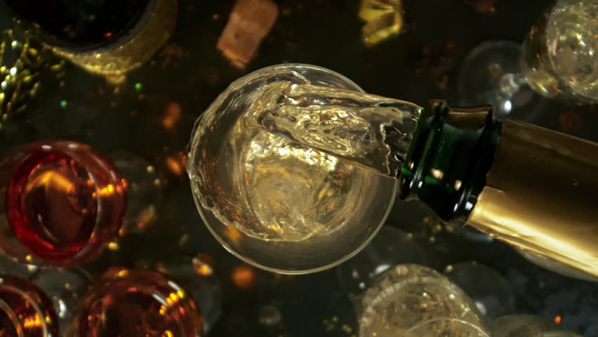 Super Slow Motion Shot of Pouring Champagne with Camera Rotating and Moving Into Liquid at 1000fps.