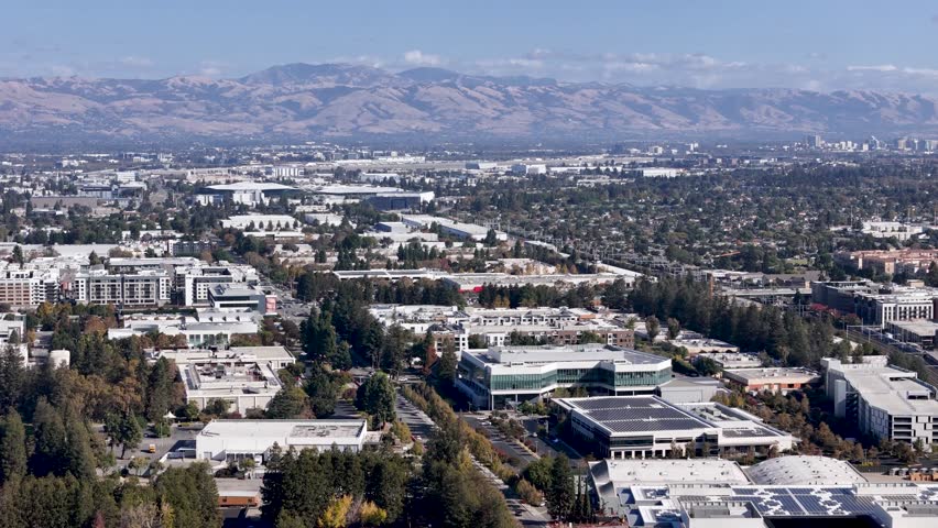 Sweeping aerial view across Silicon Valley, showing Sunnyvale with the Diablo Range and downtown San Jose on the horizon.