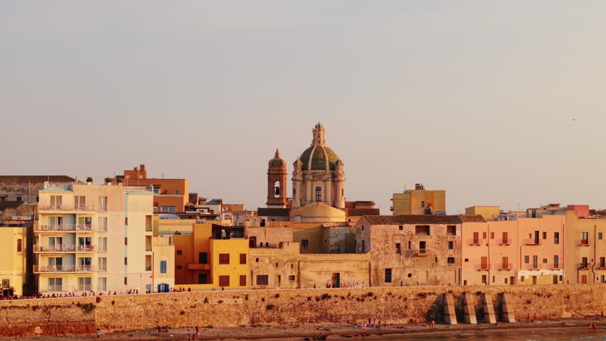 Trapani skyline during sunset, serene seafront with historic buildings