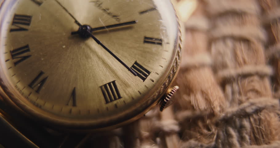 Macro Close Up Shot of Antique Pocket Watch with Roman Numerals and Running Second and Minute Hand. Vintage Design and Warm Tones. Concept of Passing Time, History, Nostalgia and Elegance. Time Lapse.