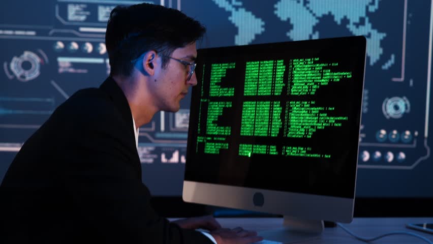Latin businessman programmer is sitting typing code at a computer screen thinking of an application to create a company security system and prevent data theft as a computer IT crime