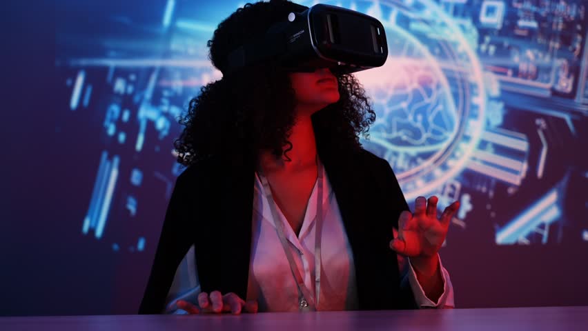 female IT developers sit in a meeting with colleagues wearing a VR headset with virtual reality technology, chatting online in a virtual reality simulator, online conference with colleagues remote - Powered by Shutterstock - Get 15% off with code: PIKWIZARD15