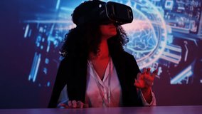 female IT developers sit in a meeting with colleagues wearing a VR headset with virtual reality technology, chatting online in a virtual reality simulator, online conference with colleagues remote - Powered by Shutterstock - Get 15% off with code: PIKWIZARD15