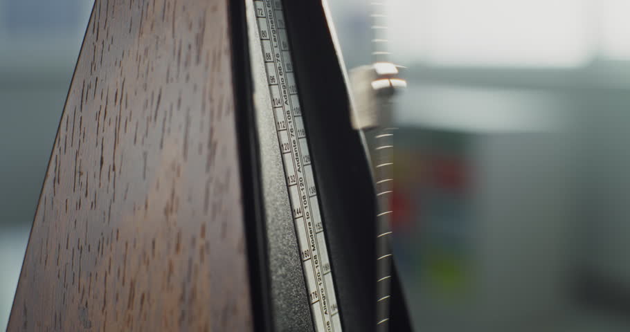 Close Up of Classic Wooden Metronome with Swinging Pendulum, Helping Musicians to Perform Music Accurately. Rhythmic Beats with Tempo to Measure Musical Rhythm. Concept of Rhythm, Timing and Practice.