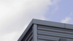 The top of a metal technical architecture against the backdrop of floating clouds in summer. - Powered by Shutterstock - Get 15% off with code: PIKWIZARD15