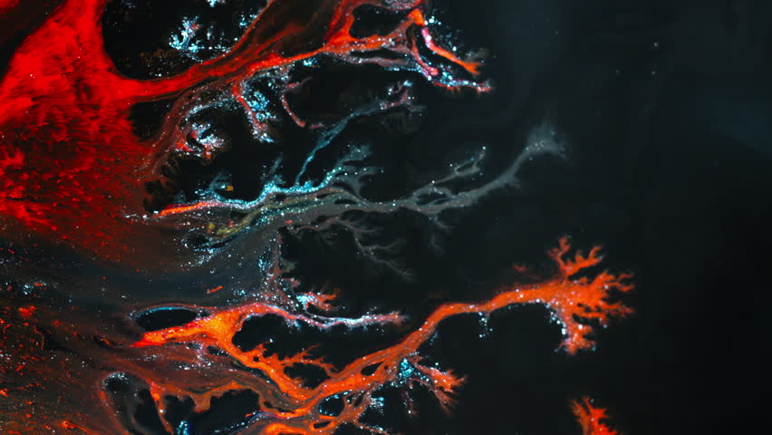 Colorful liquids merge in macro view, creating abstract patterns