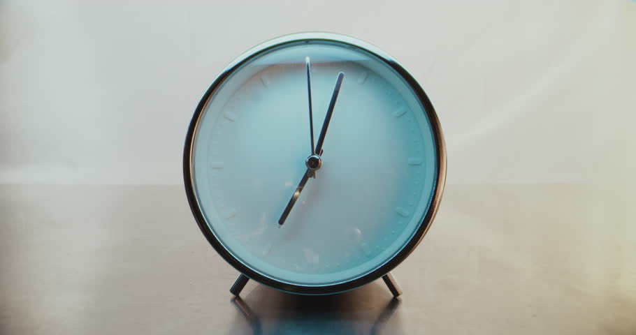 Close Up of Minimalist Round Wall Clock on Warm Background with Moving Clock Hands Showing Precise Time. Contemporary Design Element of Interior. Concept of Time Management, Punctuality, Lifestyle.