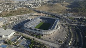 Teddy Stadium Jerusalem, israel embraces sunset warmth in this composed parallax shot highlighting quiet solitude - Powered by Shutterstock - Get 15% off with code: PIKWIZARD15