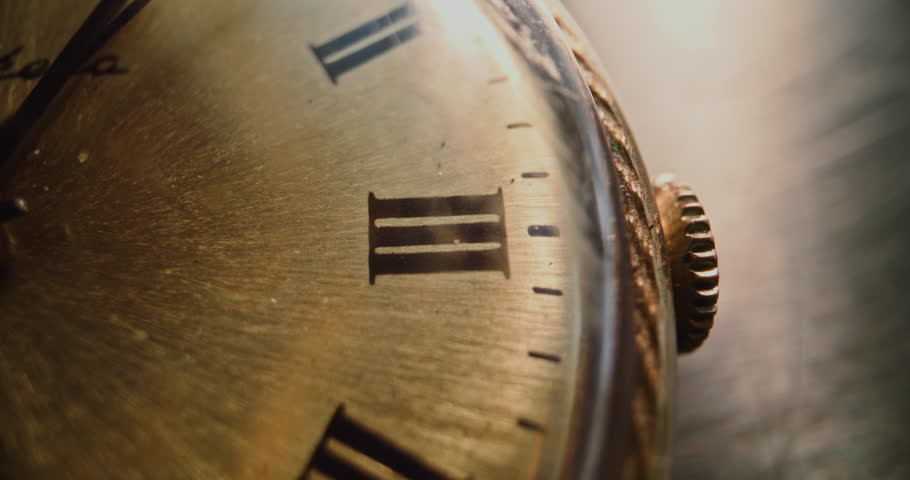 Macro Close Up Shot of Antique Pocket Watch with Roman Numerals and Running Second Hand. Vintage Design and Warm Golden Tones. Concept of Passing Time, History, Heritage, Nostalgia and Elegance.