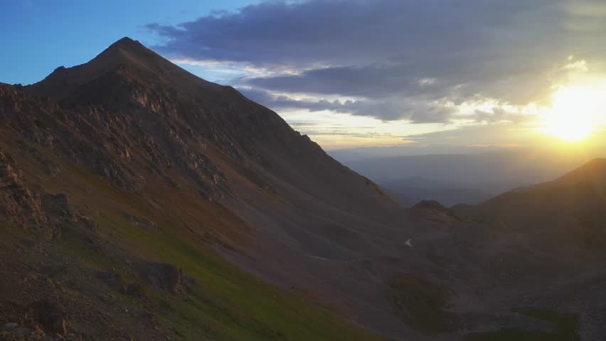 Aspen Snowmass Wilderness sunrise Capitol Peak Trailhead Ridge route Mt Daly K2 Colorado Rocky Mountain Elk Range scenic nature landscape high alpine elevation sun ray clouds pan right motion