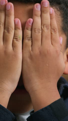 Little boy African American ethnic kid close face with hands palms happy laughing child son boy playing peek a boo game peek-a-boo play hide and seek joyful smiling at home laugh fun fooling around